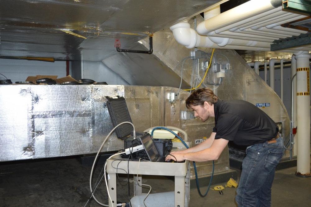 man monitoring data on a computer